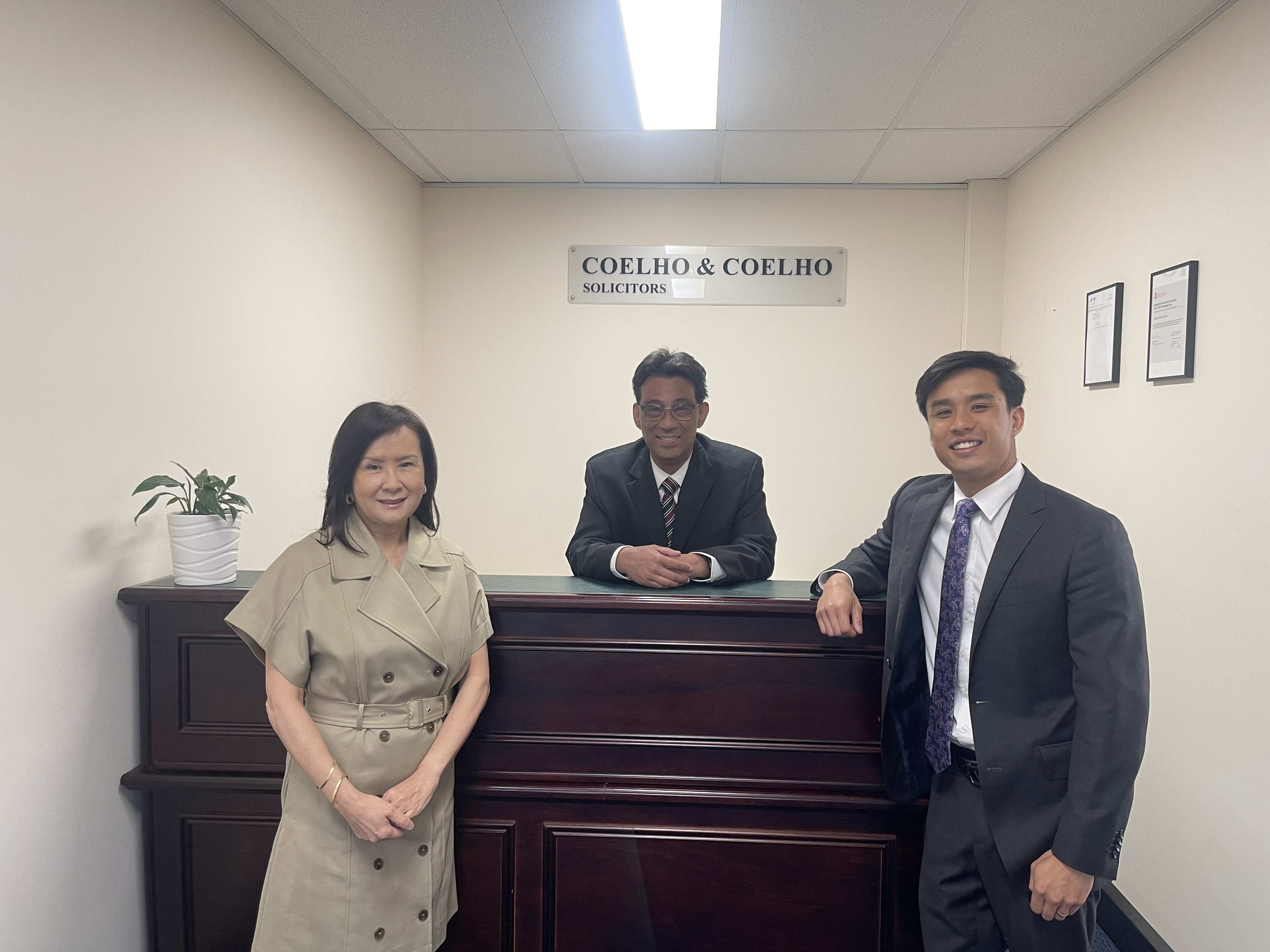 The Coelho & Coelho Lawyers team standing together in their office